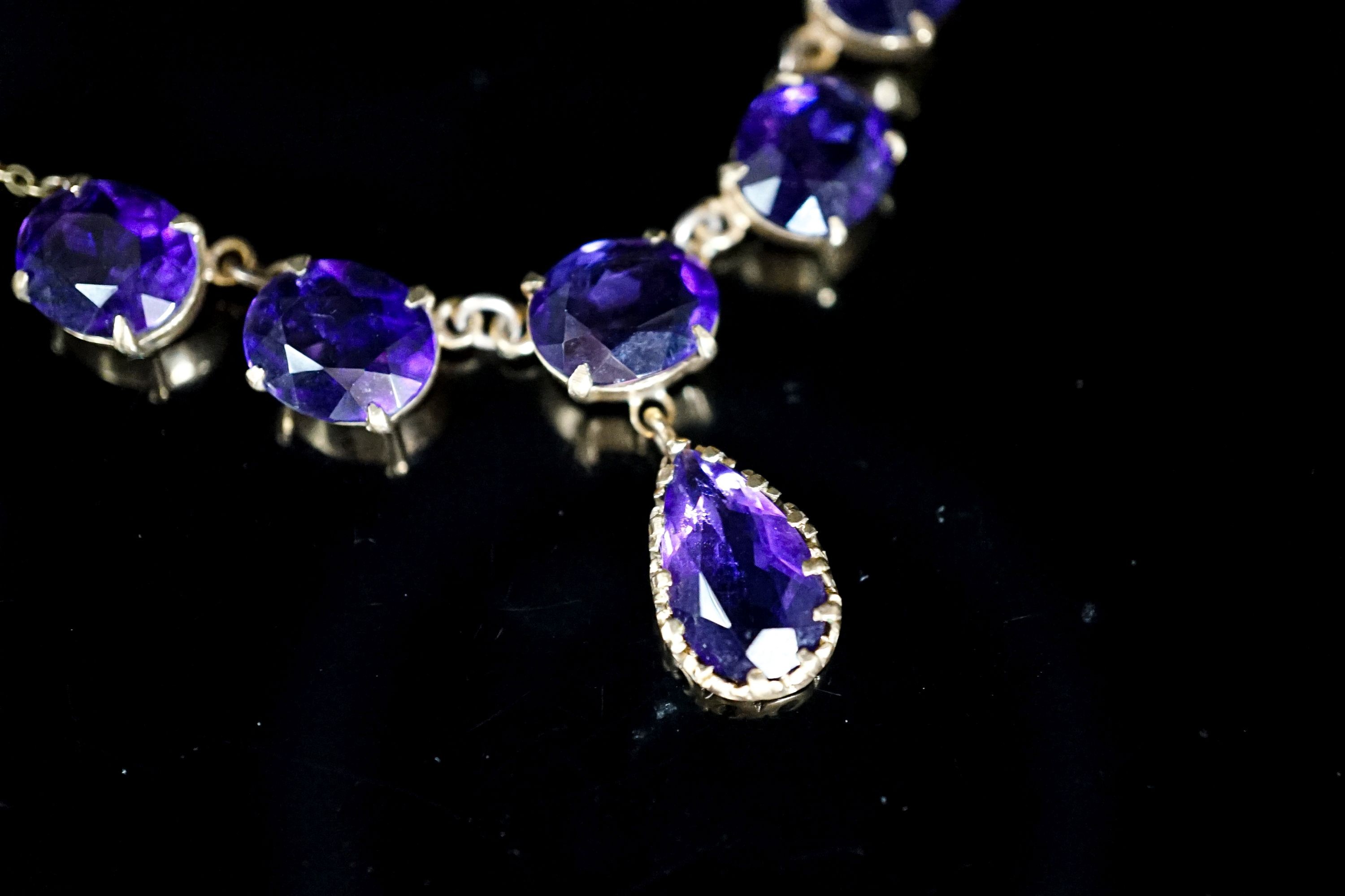 A 9ct gold and six stone oval and pear cut amethyst set drop necklace, 48 grams.7cm, gross weight 13.8 grams.